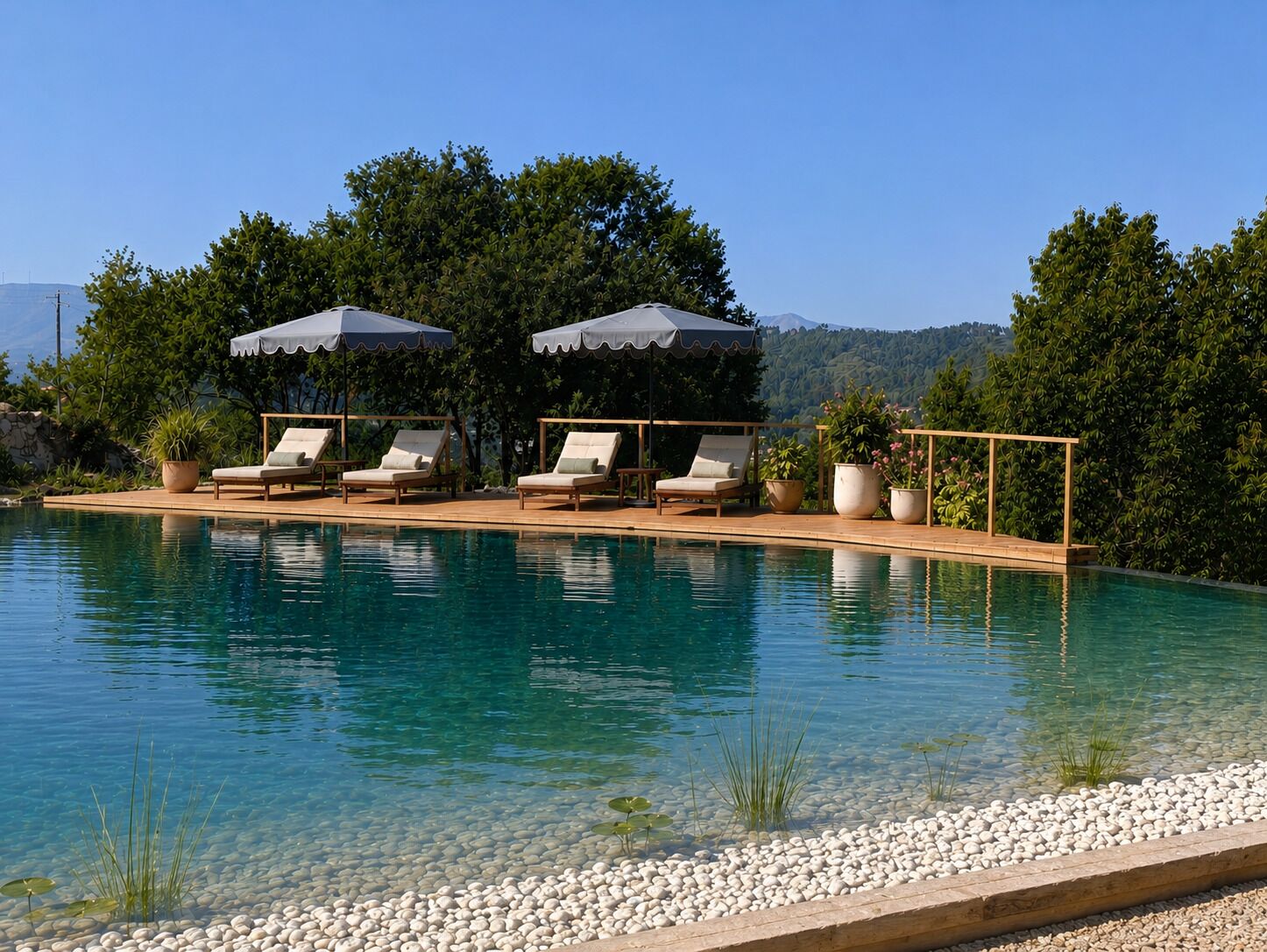 A pool with clear water, surrounded by lounge chairs and umbrellas, set against a backdrop of trees and hills.
