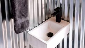 A bathroom with a white sink, a towel rack, and a mirror. - Intimate Glamping Tent near Arches National Park for a Memorable Couples Escape in Moab, Utah (Moab)