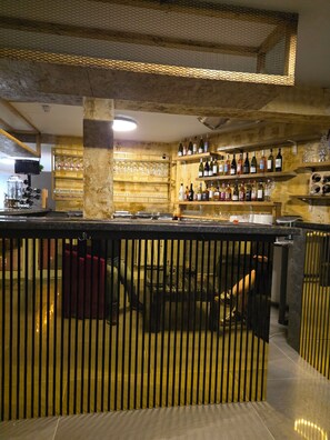 A bar area with shelves of bottles, glasses, and a counter. - Old Ridgeway Hotel (London)