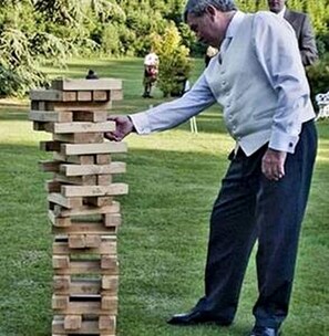 A man playing a game of Jenga on a grassy field. - Newly Renovated Cabin Perfect for a Lake and Peaceful Retreat in Texas (Jefferson)