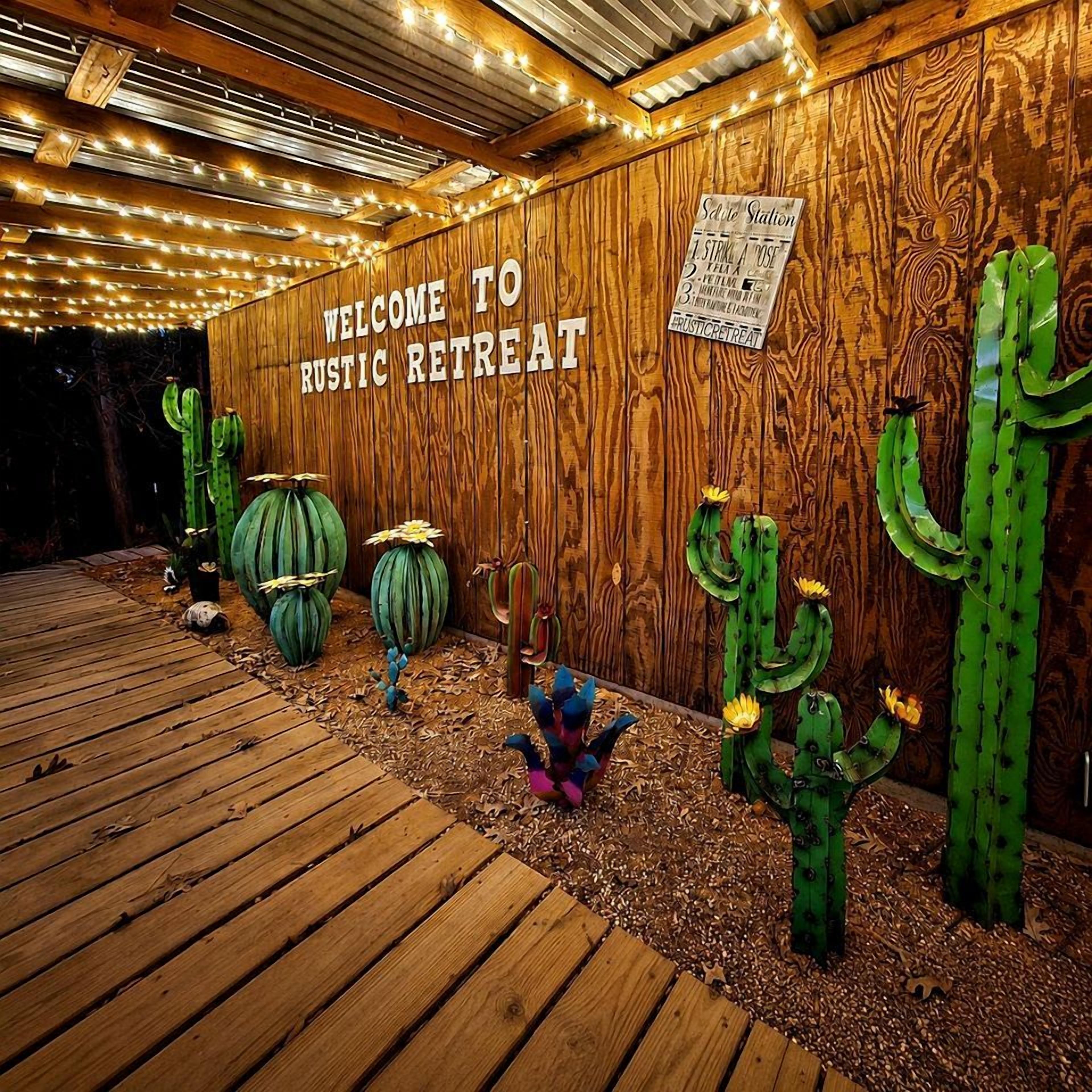 A wooden wall with a sign reading 'WELCOME TO Rustic Retreat' and decorative cacti.