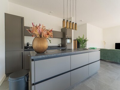 Stylish 6-person waterfront villa with three bathrooms, open kitchen with cooking island, and private dock – combining space and comfort.