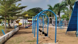A playground with swings, slides, and climbing structures. - Kakatiya Resort (Govindaraopet)
