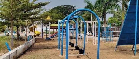 A playground with swings, slides, and climbing structures.