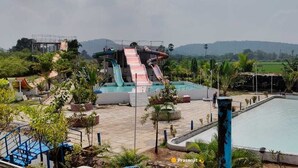 A water park with multiple slides and a swimming pool. - Kakatiya Resort (Govindaraopet)