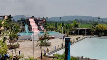 A water park with multiple slides and a swimming pool.
