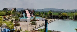 A water park with multiple slides and a swimming pool. - Kakatiya Resort (Govindaraopet)