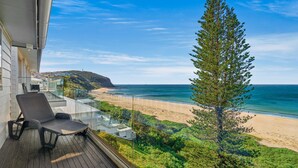 A balcony with a view of a beach and ocean. - Forresters Dunes - Upstairs (Forresters Beach)