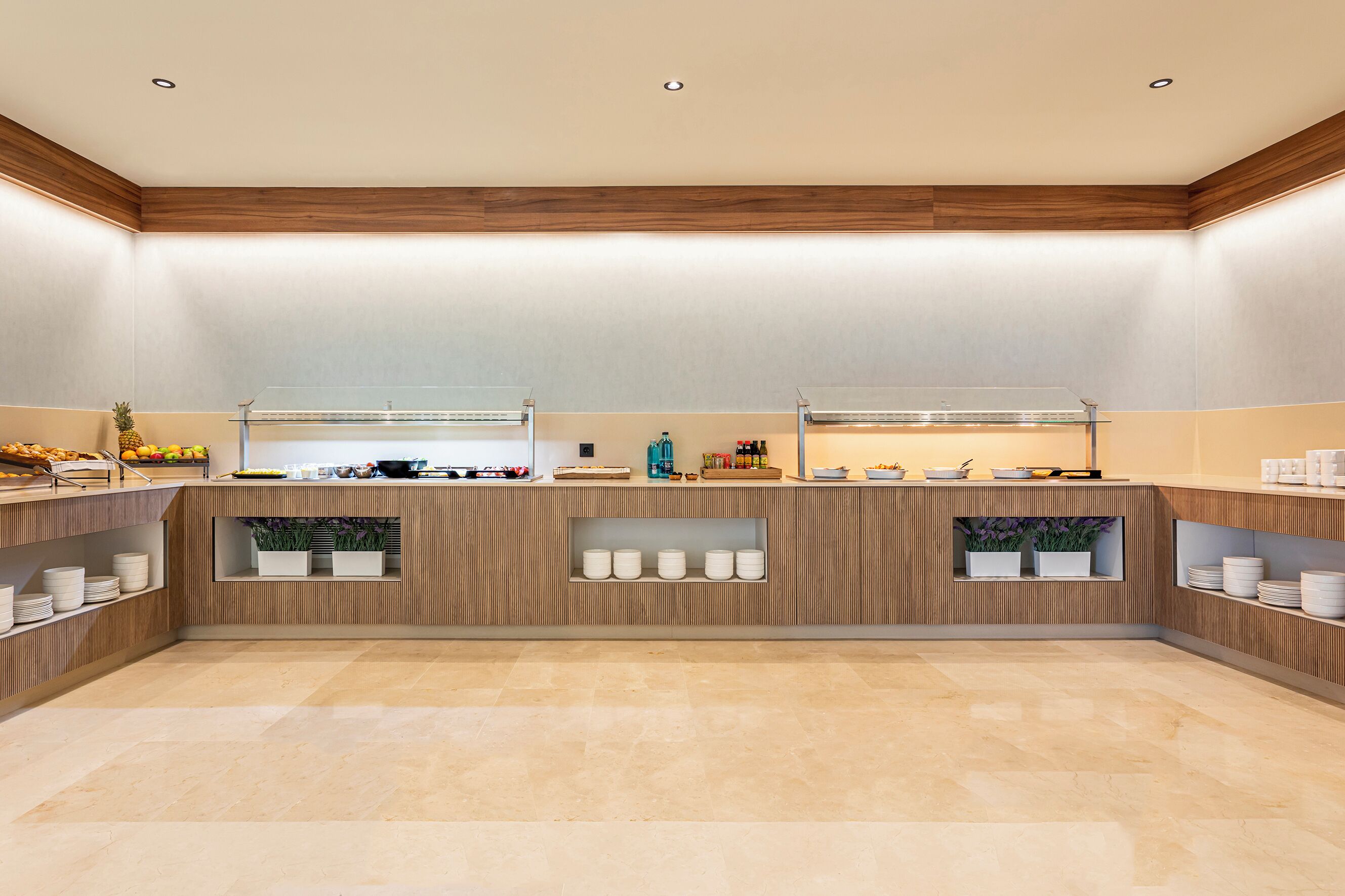 A modern kitchen with wooden cabinetry, a central island, and built-in shelves.