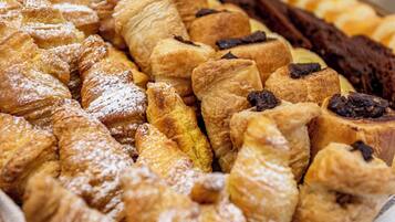 A variety of pastries including croissants and chocolate-topped pastries.
