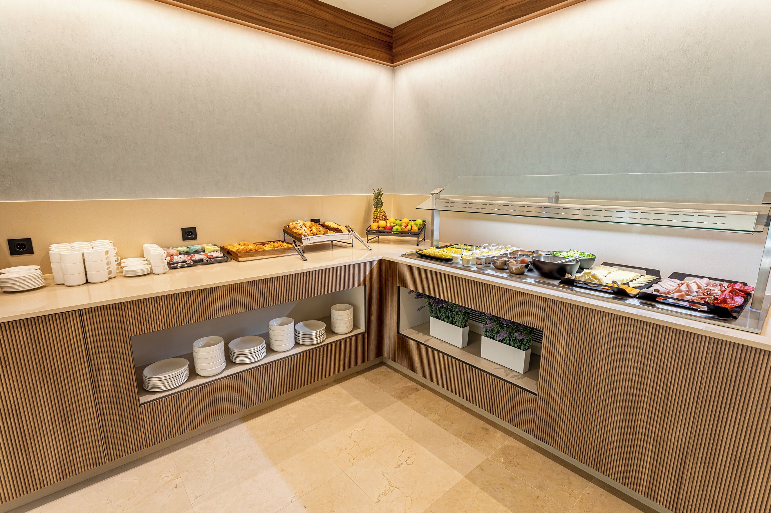 A buffet area with various food items and utensils.