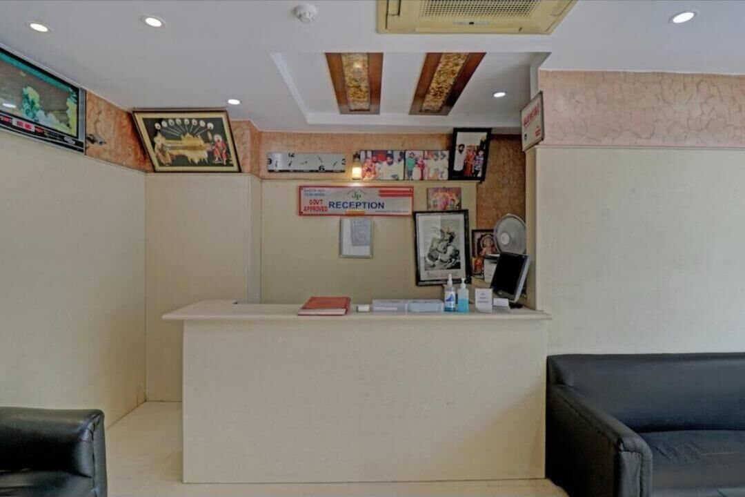 A reception area with a reception desk, a sign indicating 'Govt Approved Reception', and a few framed pictures on the wall.
