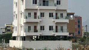 A multi-story building with a sign for "Bharathi Ultra Luxury Rooms." - BHARATHI STAYS (Tirupati)