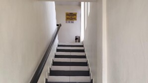 A staircase with alternating black and white steps, leading to a landing.