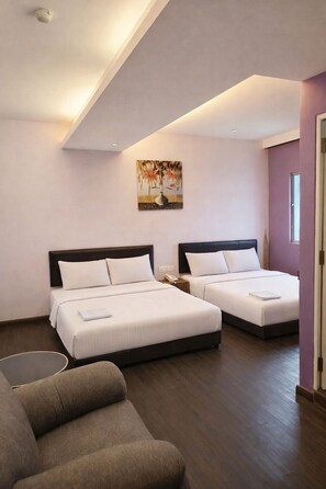 A hotel room with two beds, a sofa, a painting on the wall, and a window. - Newland Hotel by Ardens - Taman Pelangi (Johor Bahru)