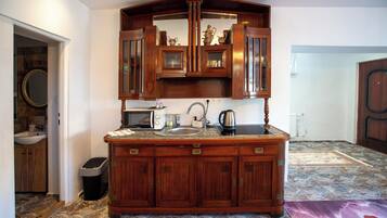 A kitchen with wooden cabinets, a sink, and a stove.
