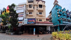 A building with a sign for 'Andaya Water Kingdom' and a 'Heaven Bar' across the street. - Stay 94 Patong (Patong)