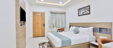 A modern bedroom with a wooden bed, a desk, and a ceiling fan.