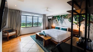 A bedroom with a large bed, a bench, a sofa, and a view of the outdoors. - Villa Marala (Parrita)