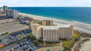 A beachfront hotel with multiple floors, a parking lot, and a view of the ocean. - Renovated Beach Front Ocean View Condo TOG 723 (Panama City Beach)