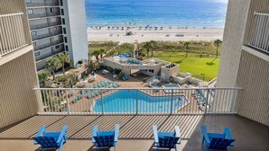 A hotel balcony with a view of a beach and a pool area. - Top of the Gulf 622 - Beach Front Condo Resort (Panama City Beach)
