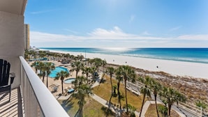 A balcony with a view of a beach, a pool, and palm trees. - Summit 505 Beach Resort Condo - Balcony Best View (Panama City Beach)