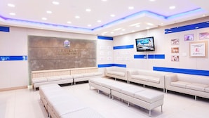 A hotel lobby with a reception desk, seating area, and a television screen. - Benikea Hotel CheongDo Hot Spring (Cheongdo)