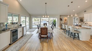 A spacious kitchen with a dining area, large windows, and a view of the outdoors. - 2 Mi to South Beach: Waterfront Home w/ Lanai! (Marco Island)