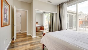 A bedroom with a large bed, a door leading to a balcony, and a framed picture on the wall. - Quiet & Convenient! Santa Rosa Family Home w/ Yard (Santa Rosa)