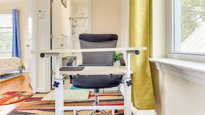 A room with a desk chair, a bed, a window with curtains, and a patterned rug. - Quiet Newark Apt Near Colleges, Arenas & Hospitals (Newark)