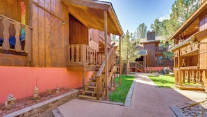 A wooden building with a porch and a staircase leading to a second floor. - 3 Blocks to Angel Fire Resort: Kid-friendly Condo (Angel Fire)