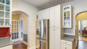A kitchen with white cabinetry, a stainless steel refrigerator, and a red countertop. - Walk Everywhere! Dtwn Washmo Home Near Wineries (Washington)