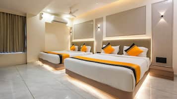 A modern hotel room with two beds, a ceiling fan, an air conditioning unit, and a large window with curtains.