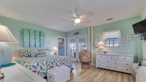 A bedroom with a bed, a chair, a dresser, and a television. - Legasea - Ocean Front home with direct Beach Access, Large Decks, great for larg (Carolina Beach)
