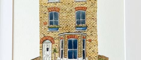 A two-story building with a brick facade, a central bay window, and a door with a small porch.