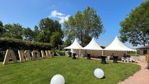 A grassy outdoor area with tents and large wooden letters spelling "AMOUR". - Coeur de Combray, sleeps 44 with pool & function space set in beautiful gardens (Ernes)