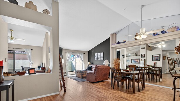 A spacious living area with a dining table, chairs, and a sofa. There is a kitchen area with a counter and cabinets. - Chilled Tempe Oasis Shaded BBQ Lounge Near ASU 2 Bedroom Home (Tempe)
