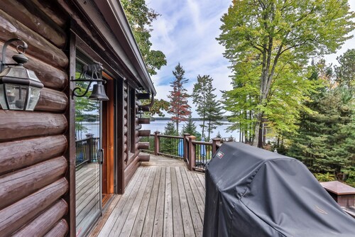 Large lakeside log home with air-hockey, foosball, dock, enclosed porch, firepit