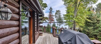 Large lakeside log home with air-hockey, foosball, dock, enclosed porch, firepit