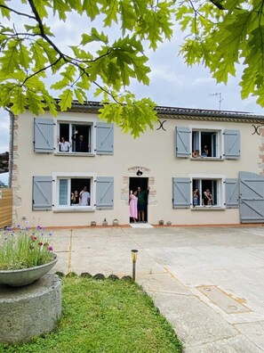 A two-story building with multiple windows and a central entrance.
