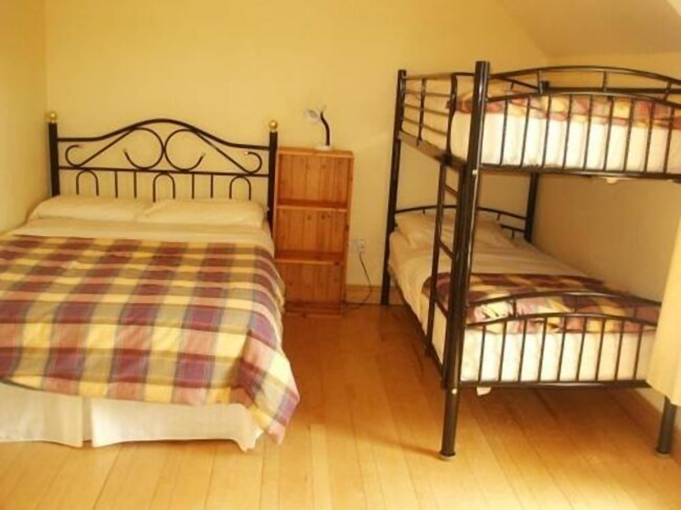 A room with a single bed and a bunk bed.