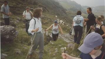 A group of people hiking on a rocky mountain trail.