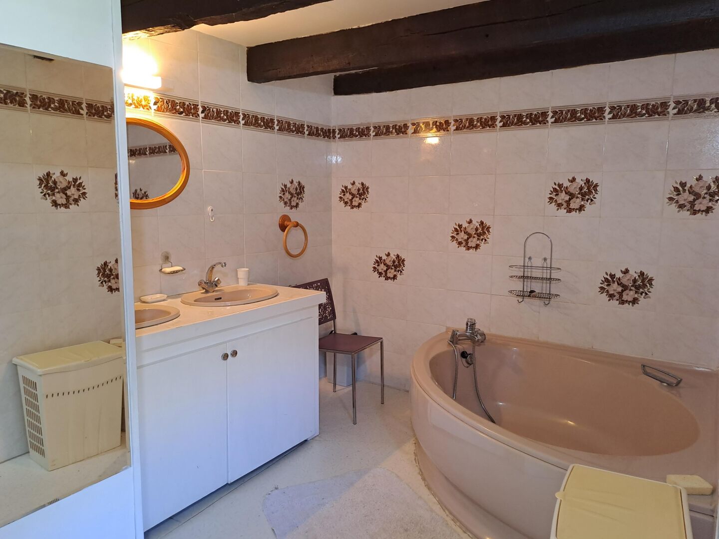 A bathroom with a bathtub, a sink, and a mirror.