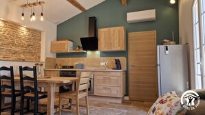 A compact kitchen with wooden cabinets, a built-in oven, and a refrigerator. - Le Chinchilla - GAILLAC (GAILLAC)