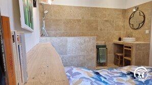 A modern bathroom with a shower, sink, and a wooden vanity. - Le Chinchilla - GAILLAC (GAILLAC)