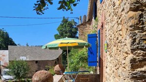 A stone building with a staircase leading to a terrace.