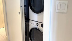 Ein Waschraum mit zwei Waschmaschinen und einem Trockner.