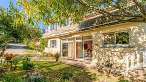 A two-story building with a garden in front, a balcony, and a door with a glass panel. - Holiday Home 'Gîte - Le Samiege' with Private Terrace, Shared Garden and Wi-Fi (Goudargues)