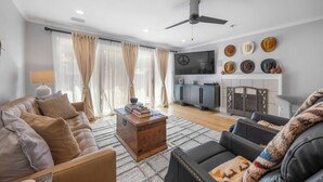 A modern living room with a sofa, coffee table, and a fireplace.