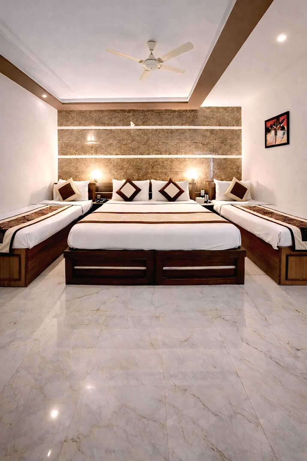 Una camera d'albergo moderna con un letto grande, una ventola a soffitto e un pavimento in marmo.